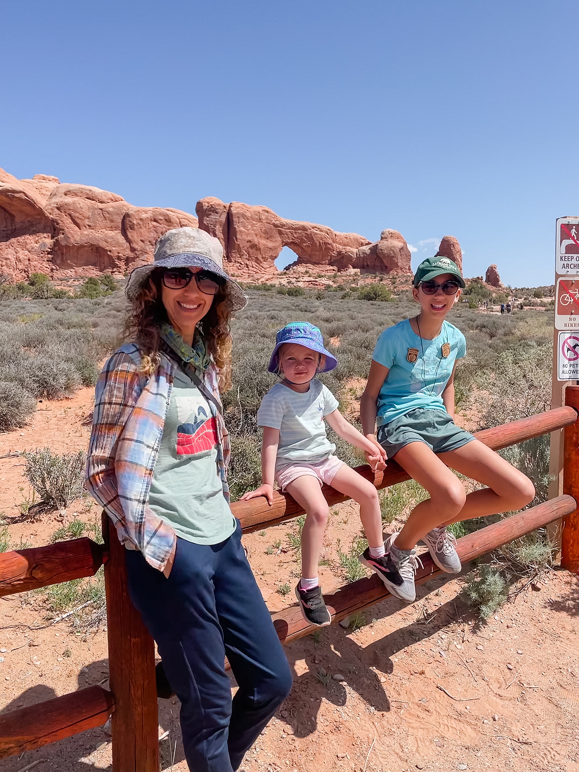 family sitting on bench during family vacation in Utah