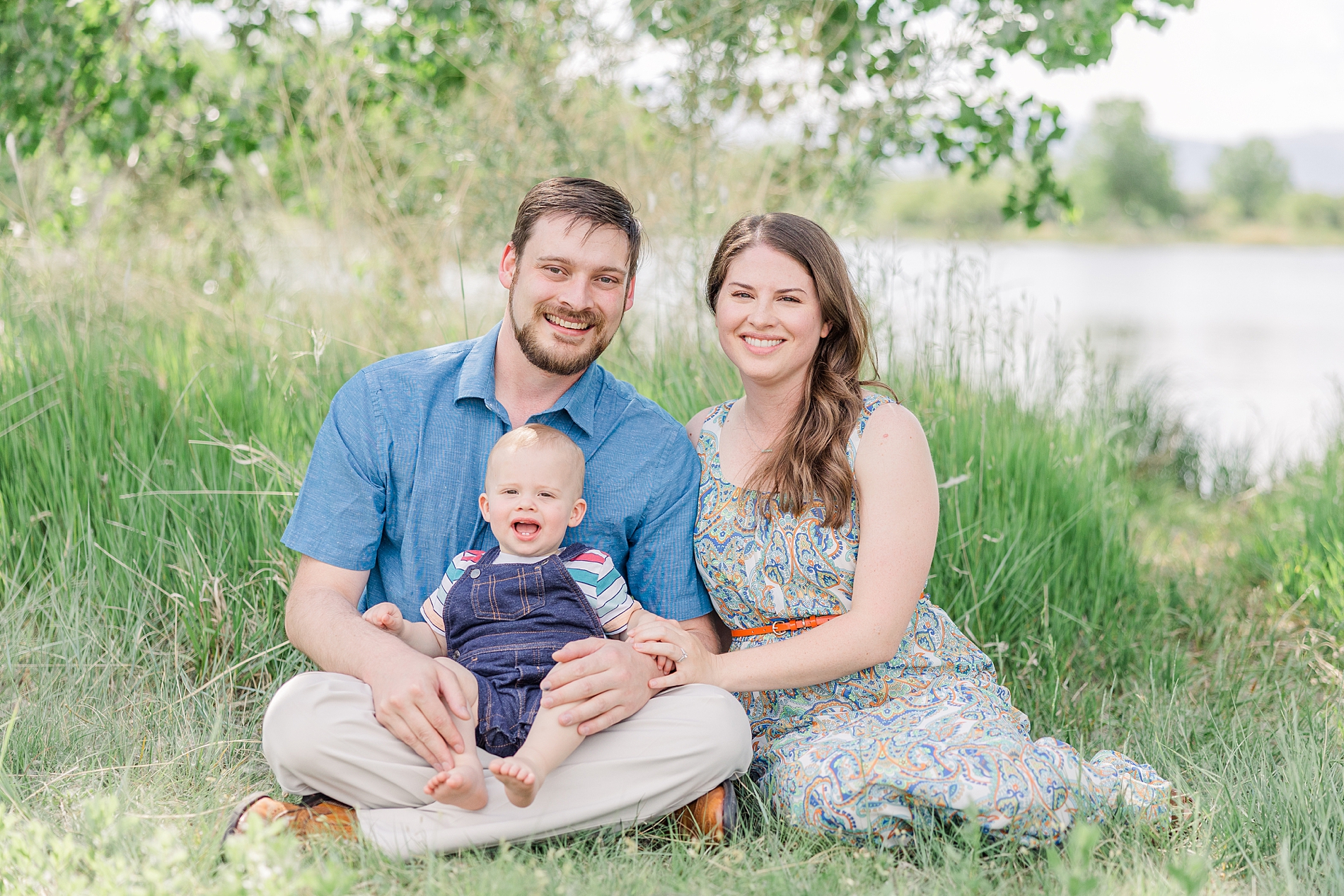 mom and dad sit with their son during Father's Day Mini Sessions at Golden Ponds by Longmont, CO Family Photographer