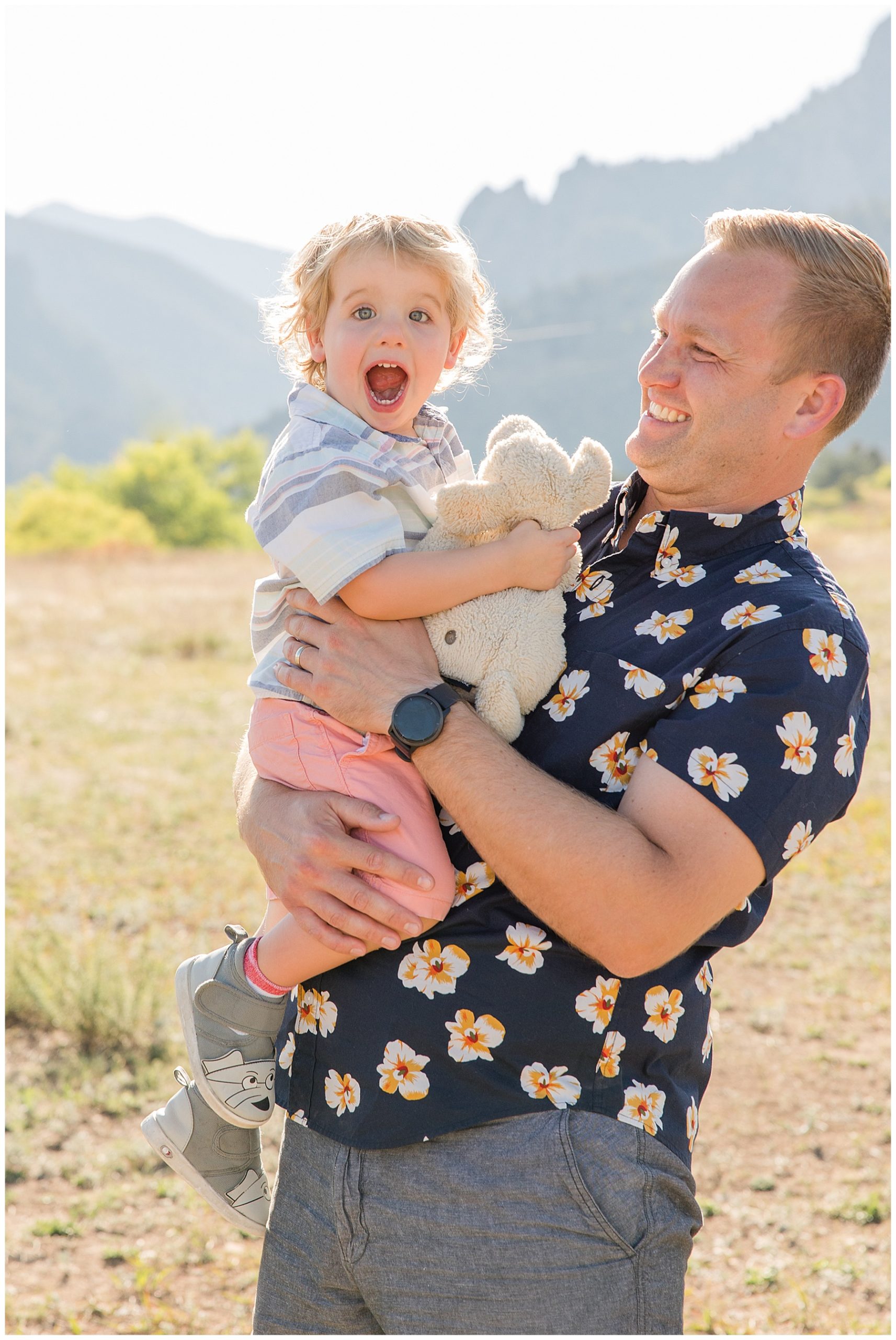 dad holds his son while the boy gleefully smiles at northern CO family photographer