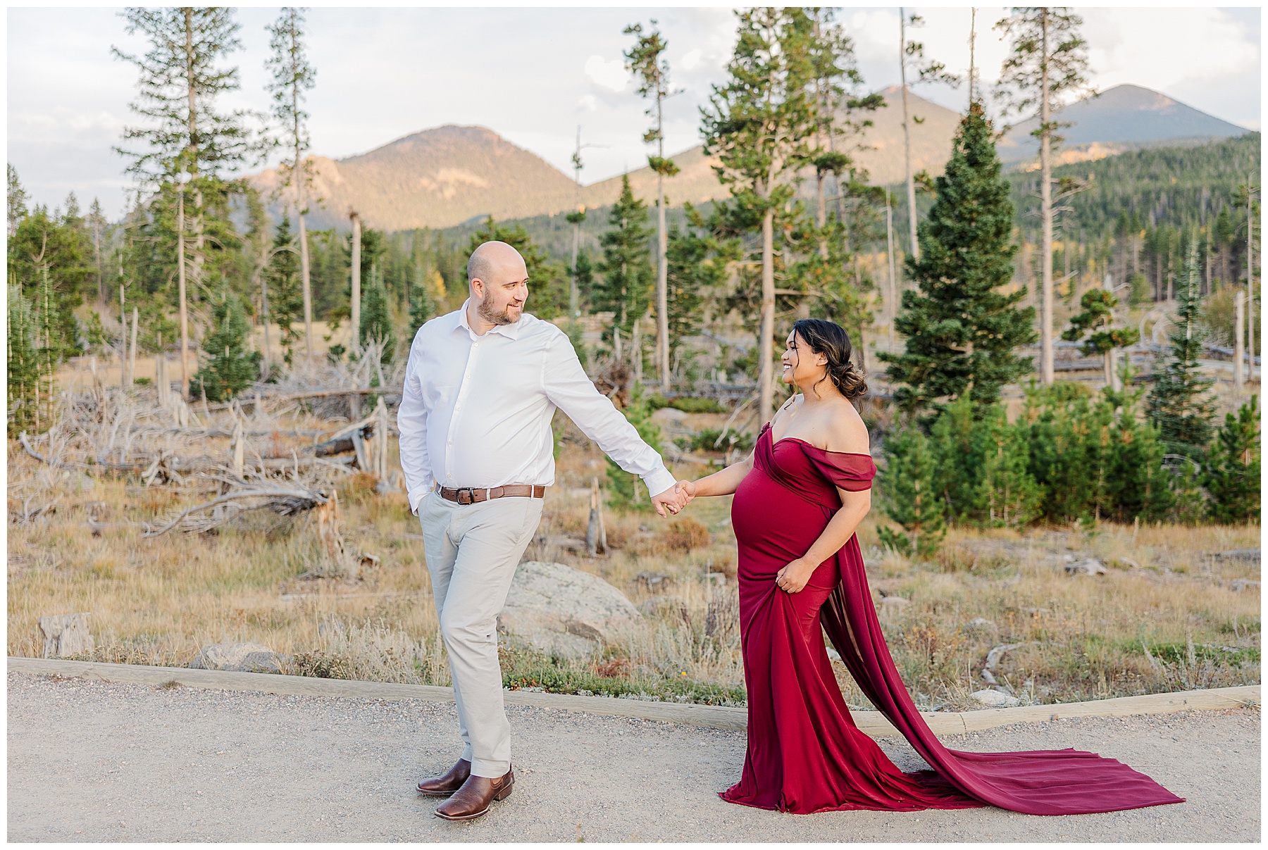 dad leading pregnant mother with fall background at maternity session in CO