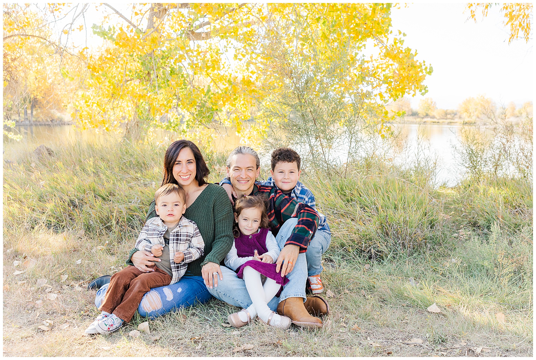 parents hold kids on lap for family picture in Northern Colorado