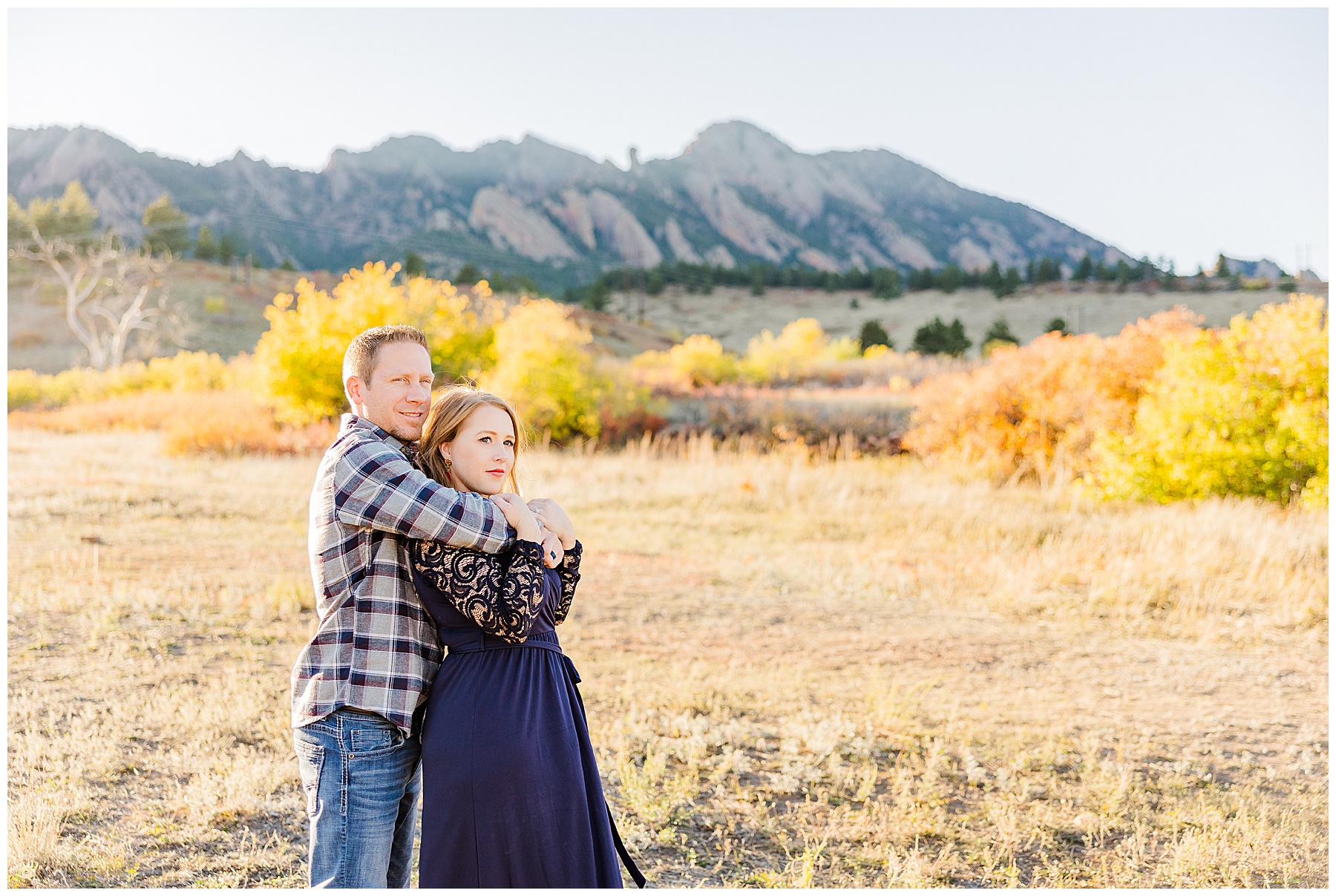 couple looks off into the distance during fall mini session in Boulder, CO