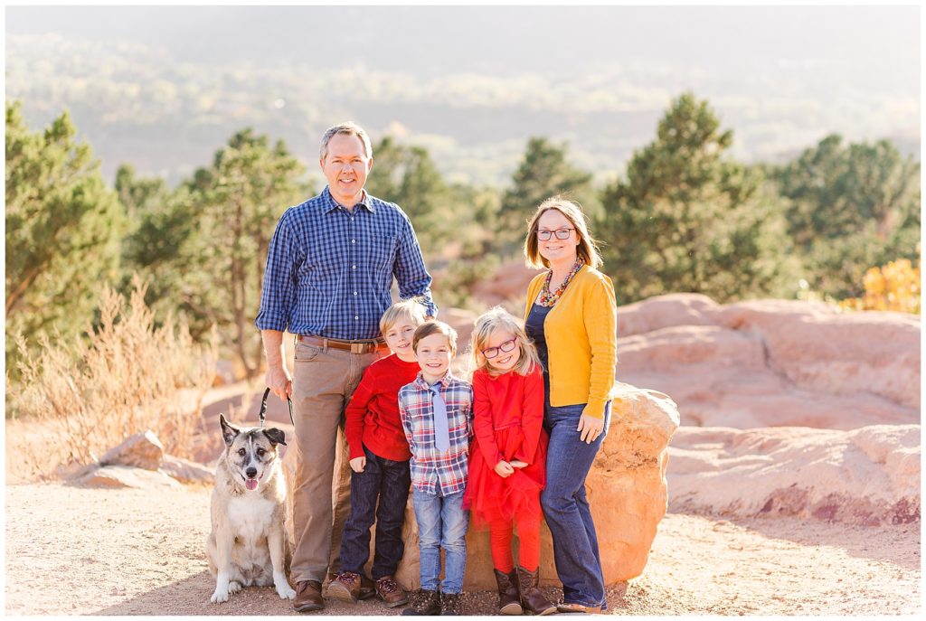 Family with young kids pose with their dog at Garden of the Gods