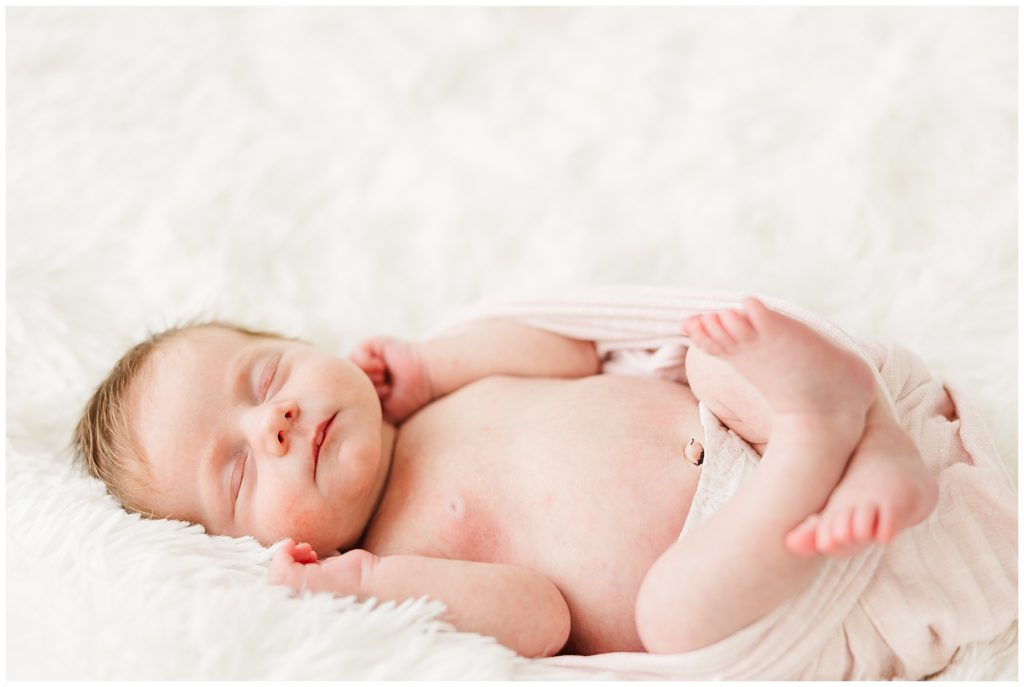 Newborn sleeps on her back and poses for Catherine Chamberlain Photography
