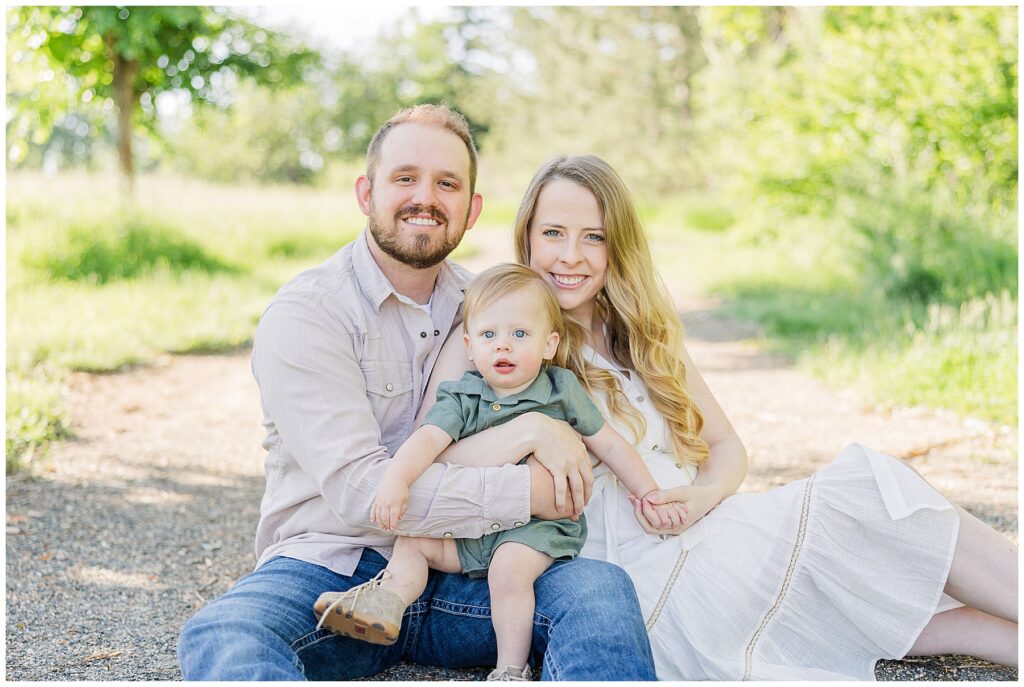 Family of three pose for outdoor light and airy photos during South Denver Moini Sessions