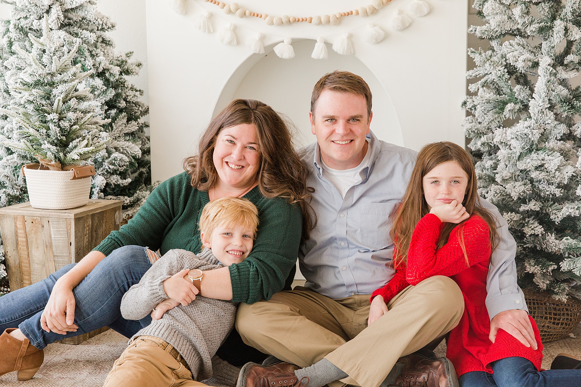 family sit close together during a christmas family mini session