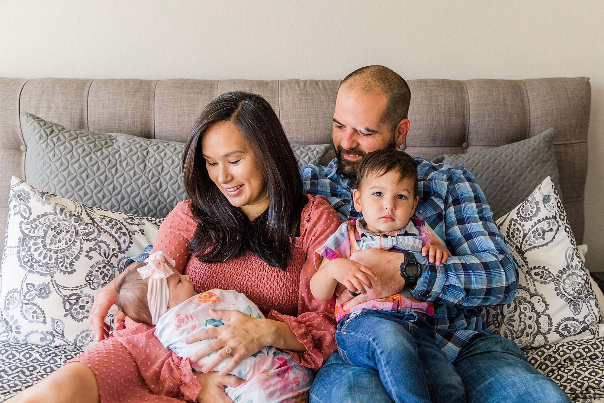 new family of four during in-home lifestyle newborn session