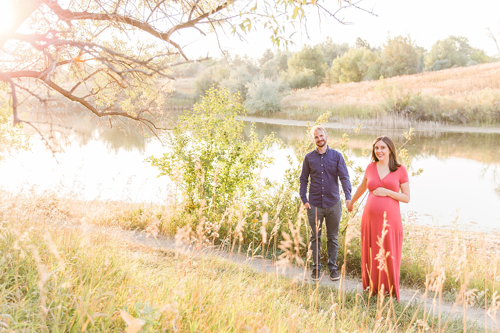 couple hold hands at Majestic View Park during Maternity Session in Arvada, Colorado