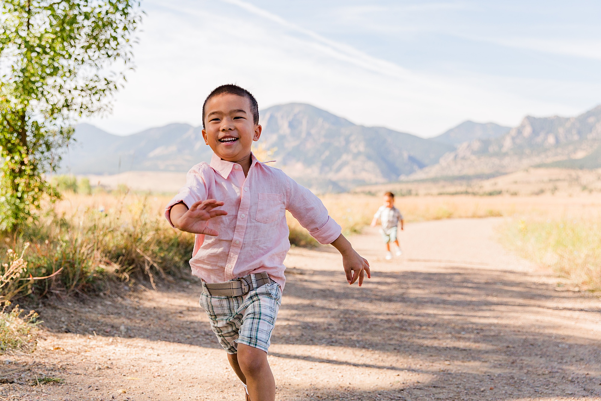 young boy runs and plays during family photos