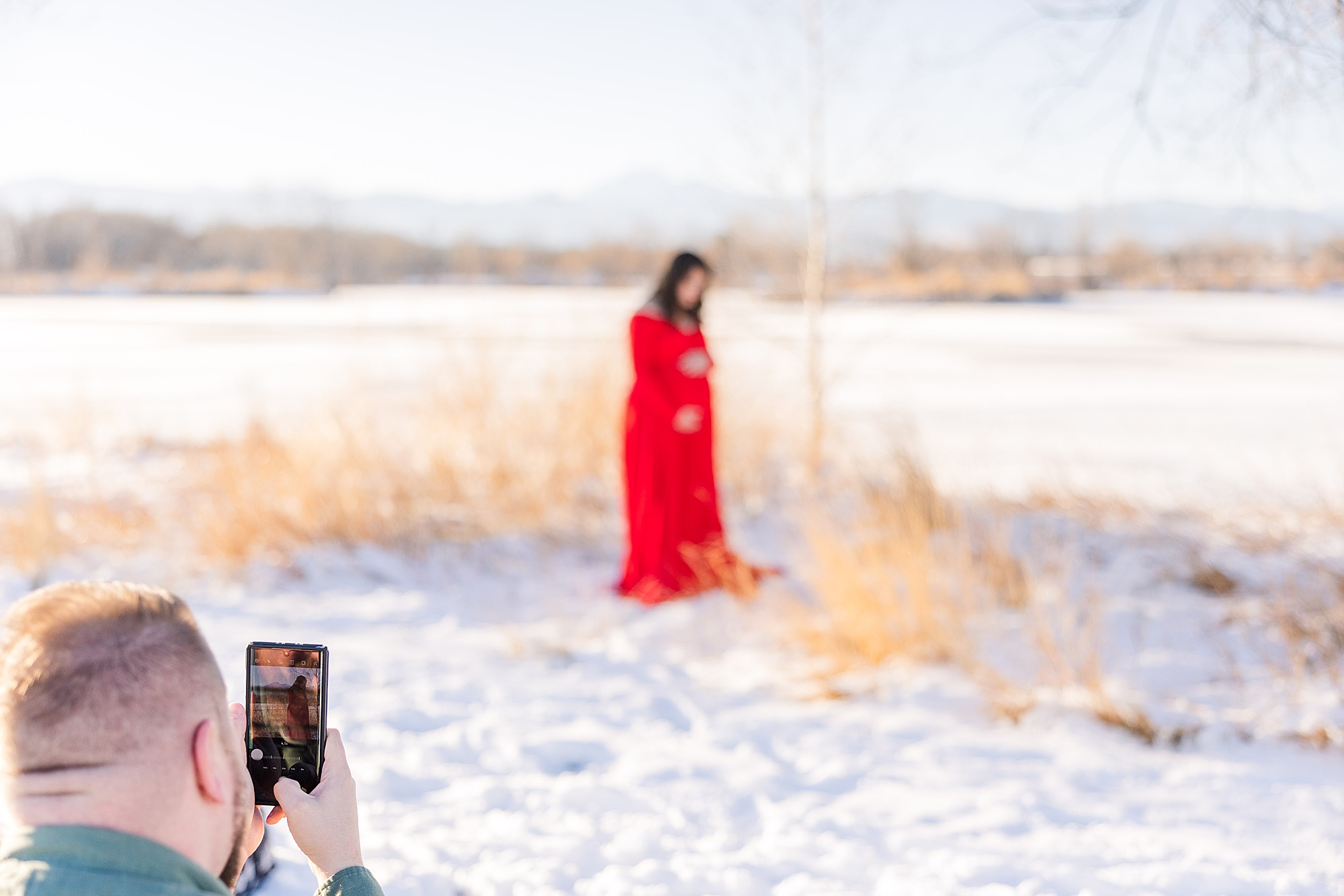 Longmont CO Maternity Photographer captures husband taking photos of his beautiful pregnant wife
