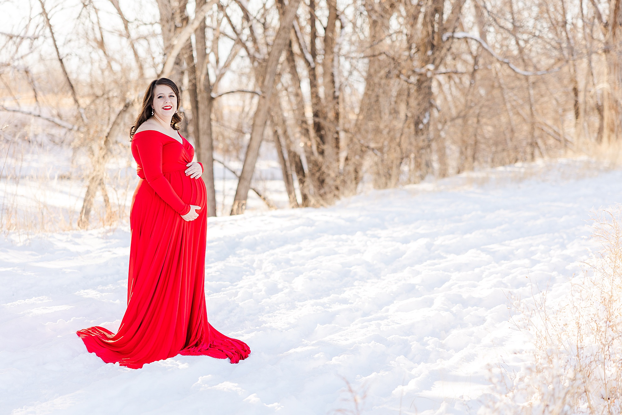 maternity portraits of expecting mom in red flowing dress