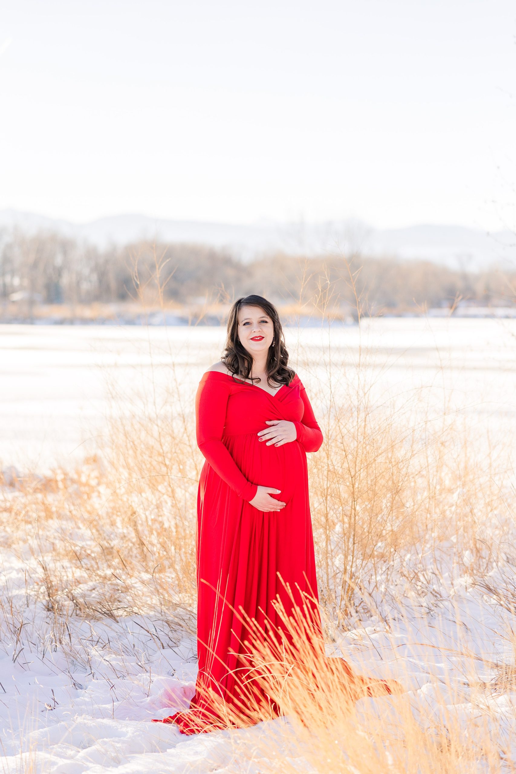 woman in red maternity dress in Longmont CO maternity session