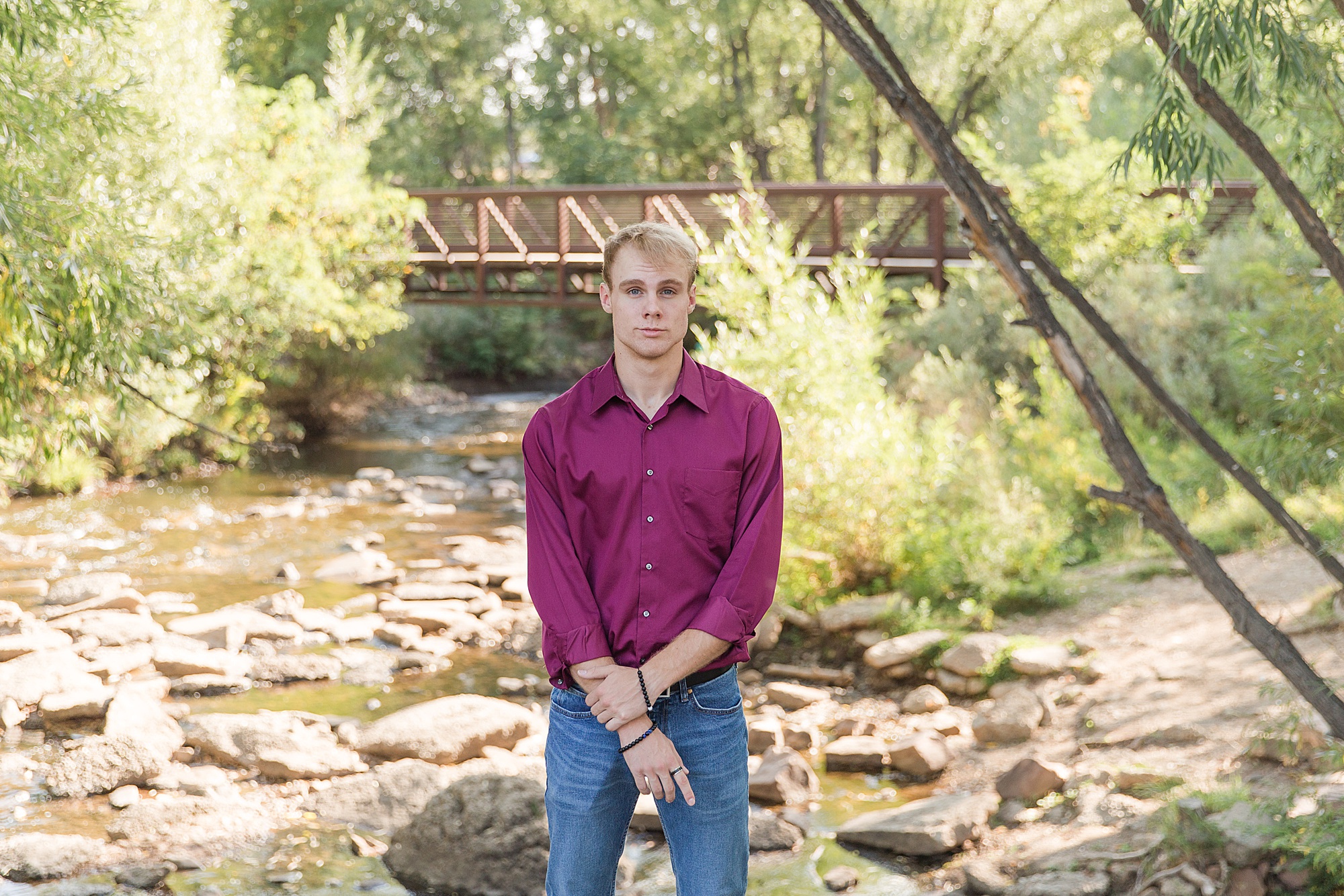 senior guy stands in creek at Golden ponds