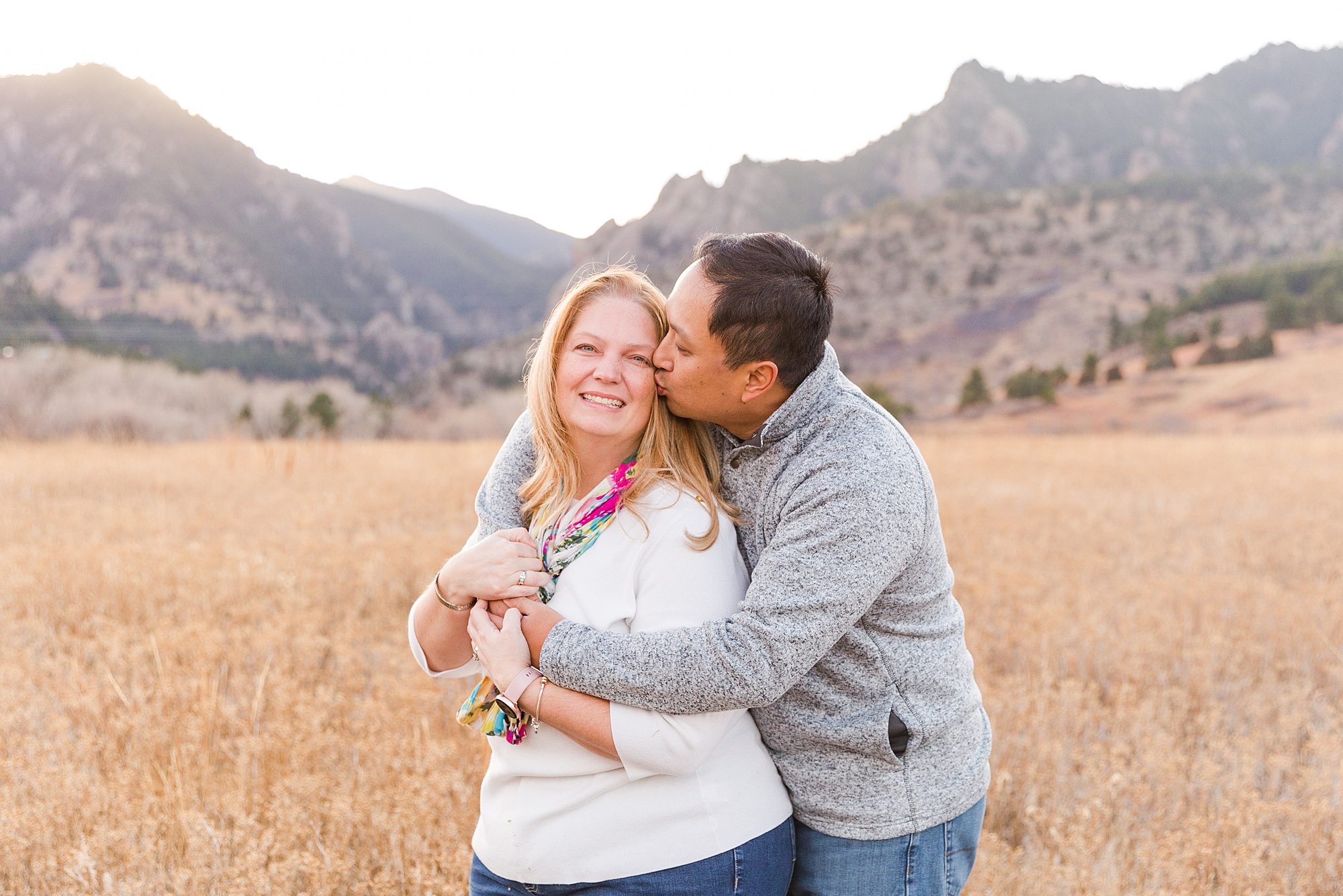 husband hugs and kisses wife during CO Family ssession