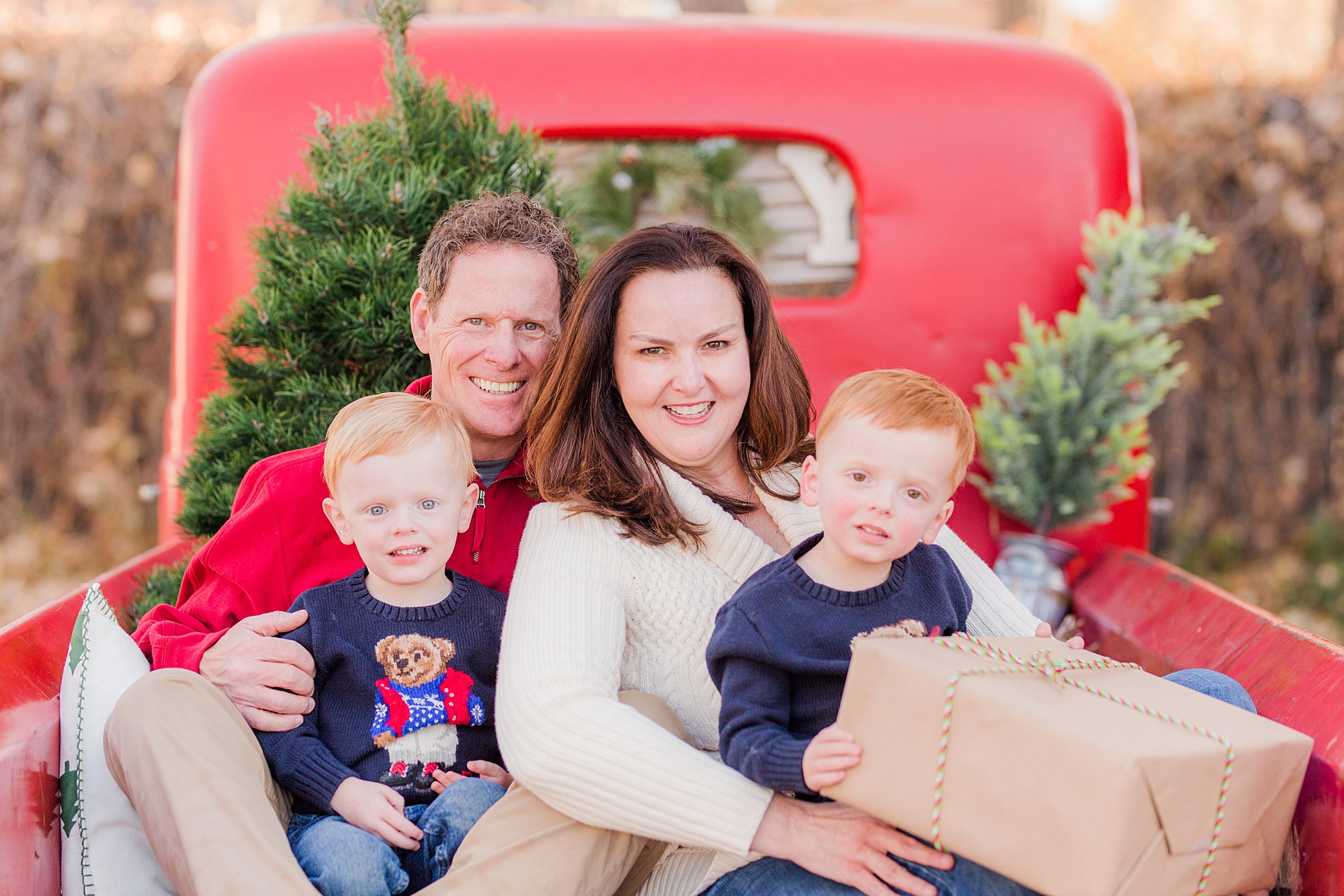 Christmas Red Truck Mini Sessions in Loveland, Colorado featuring family of 4