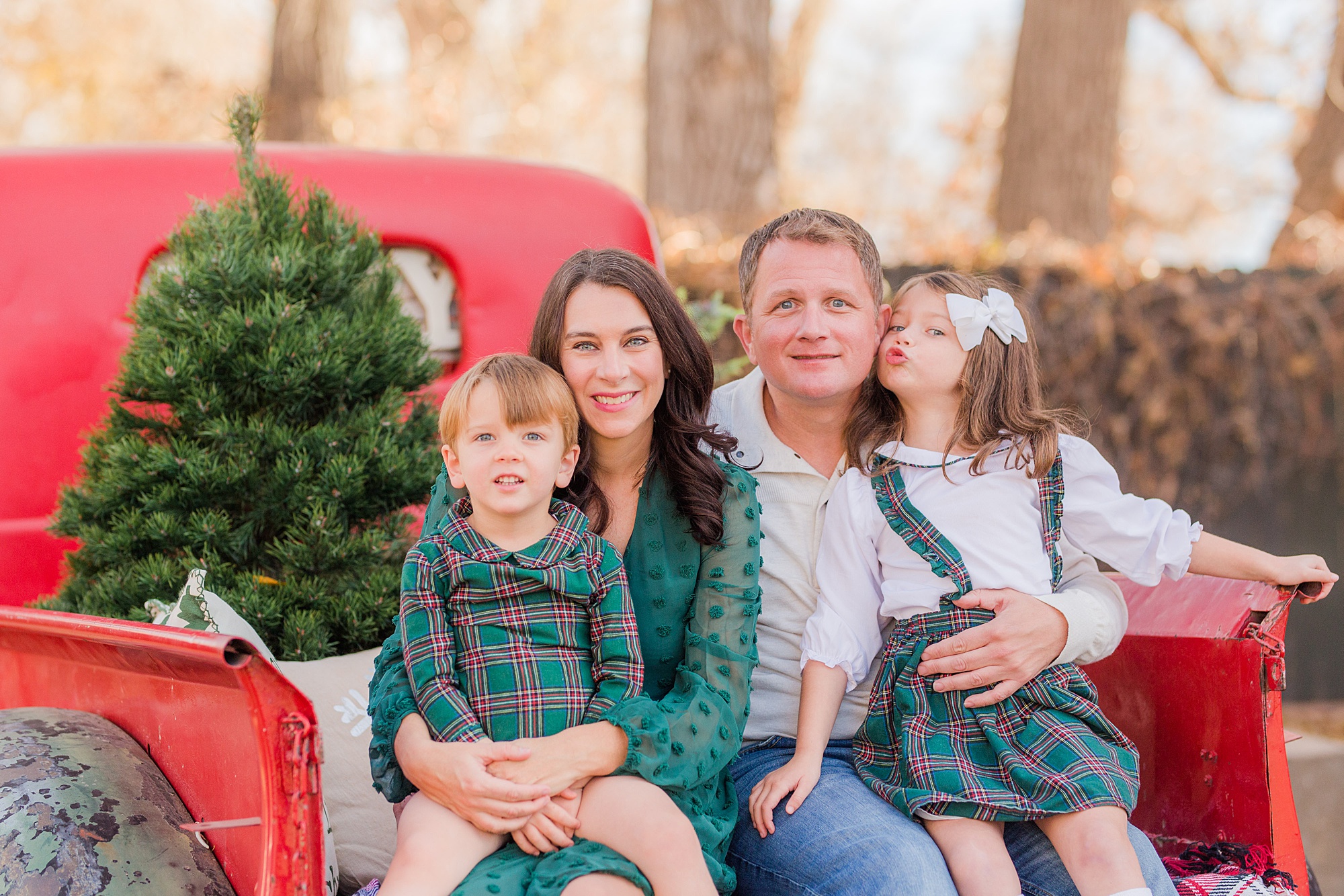 family poses during Christmas Red Truck Mini Sessions