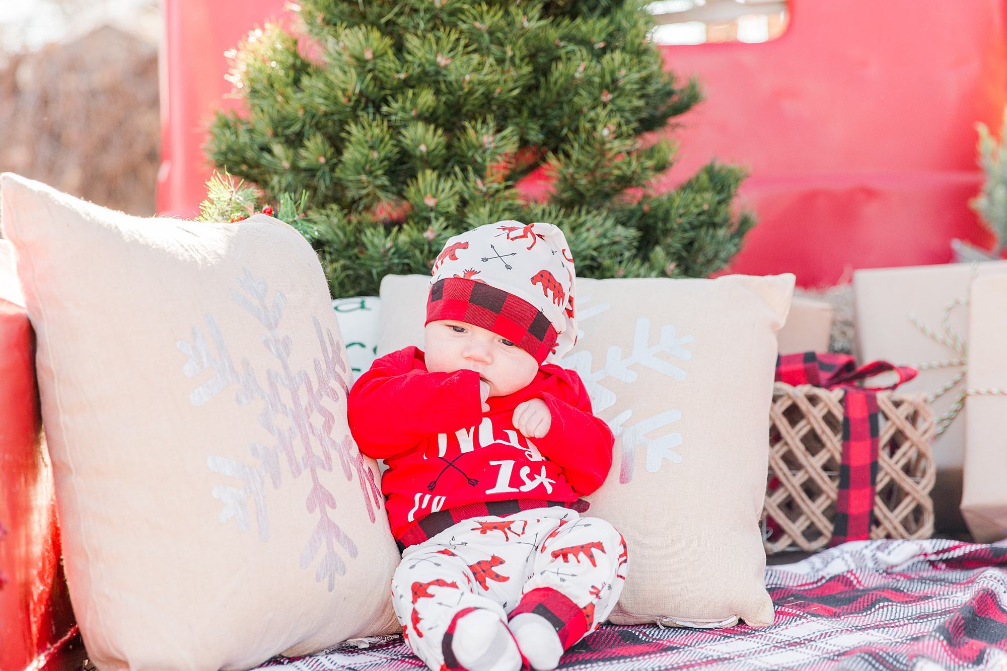 baby boy in christmas outfit during Christmas Red Truck Mini Sessions