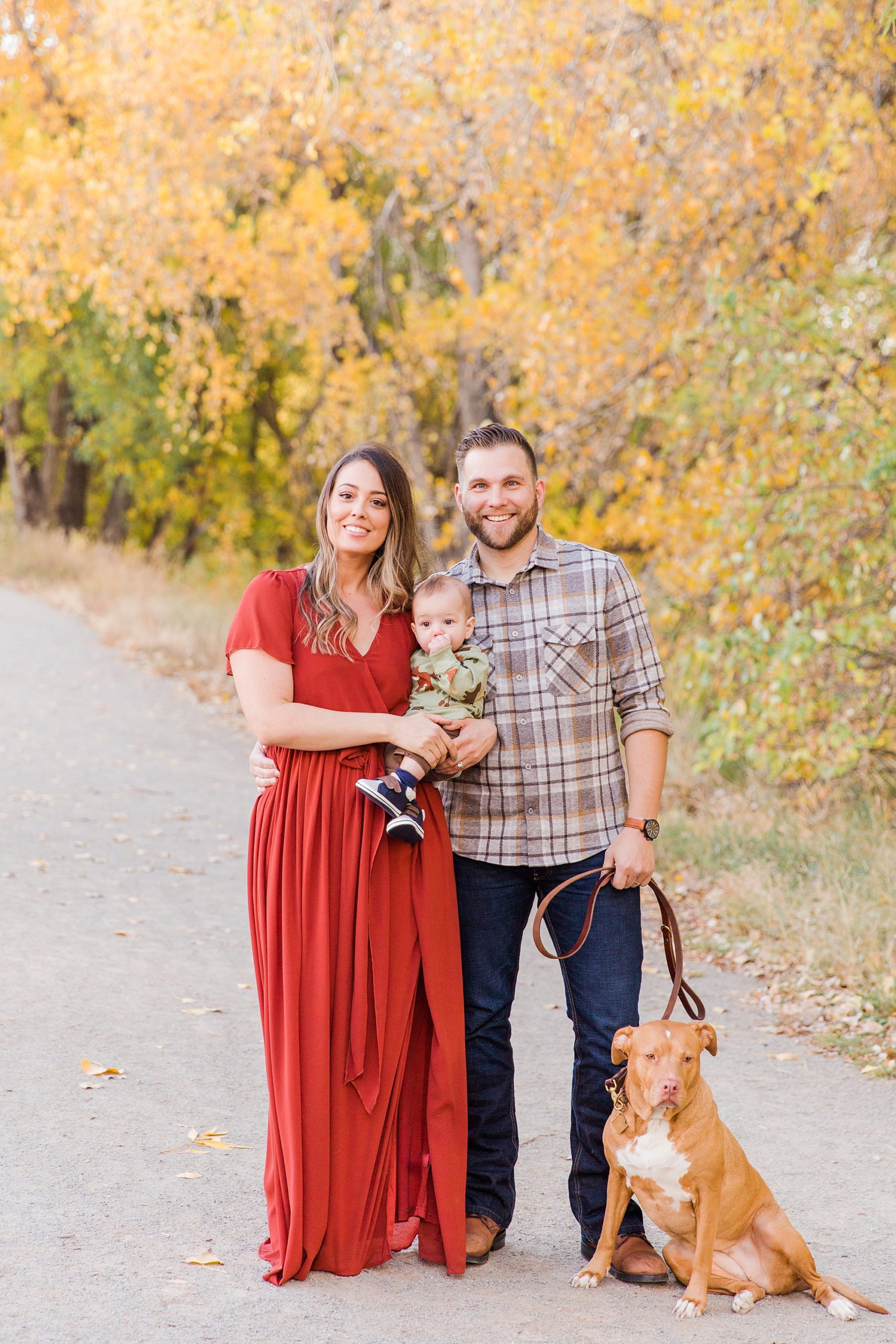 family of three with their pup during Golden Ponds Family Portraits