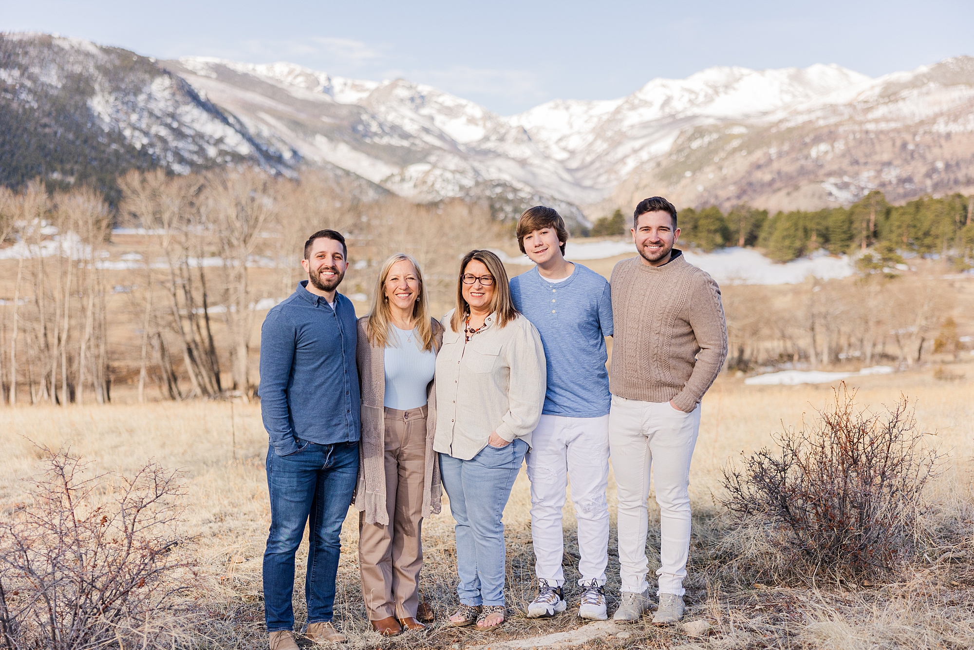 family in front of mountains at Moraine Park in Rocky Mountain National Park