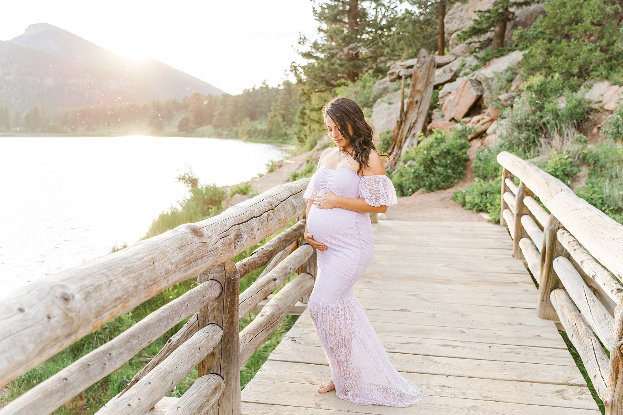 maternity session at Rocky mountain national Park on bridge by lake