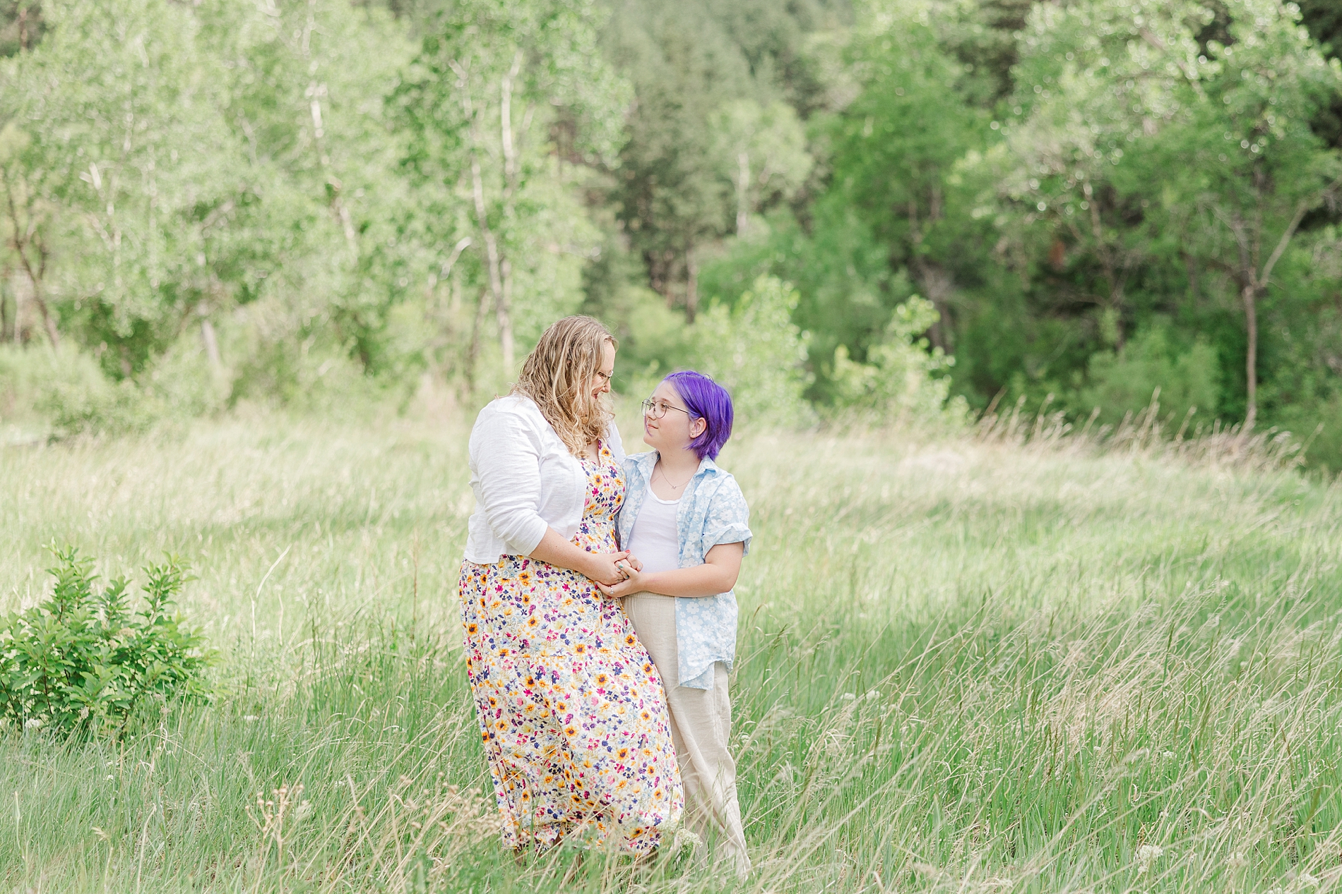 mother and daughter in field of tall grass