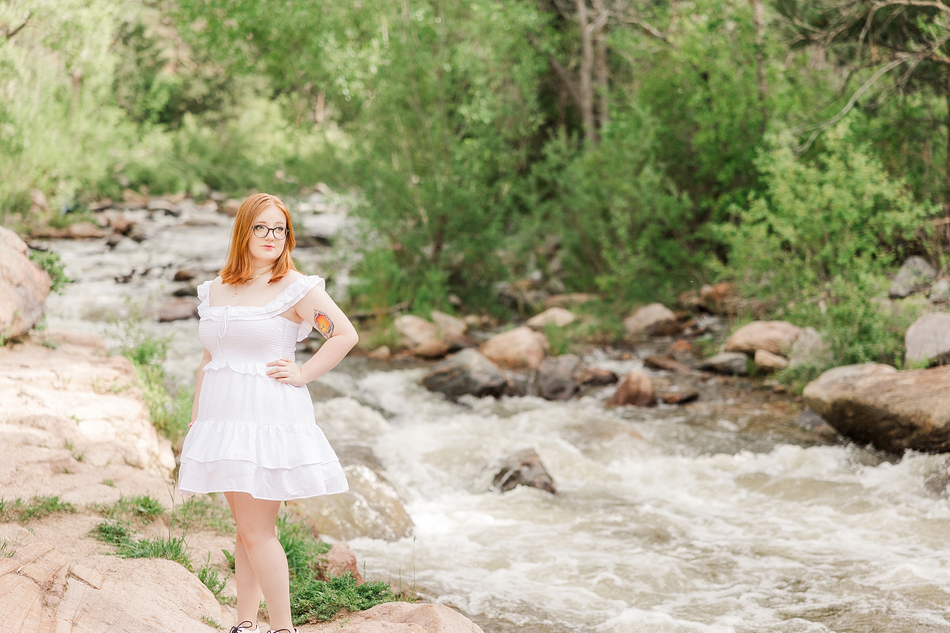 oldest daughter stands by rushing water over creek