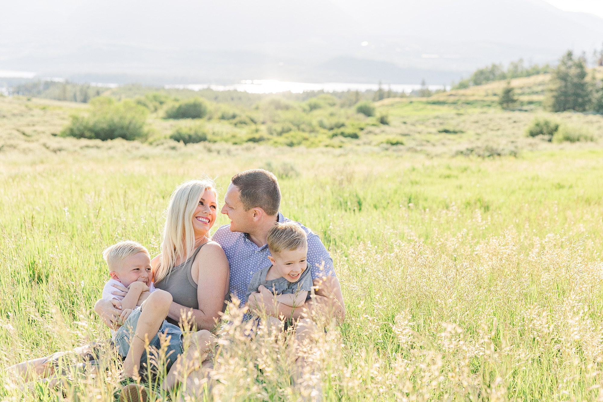 family of four sit together during Scenic Dillon CO Family Portraits