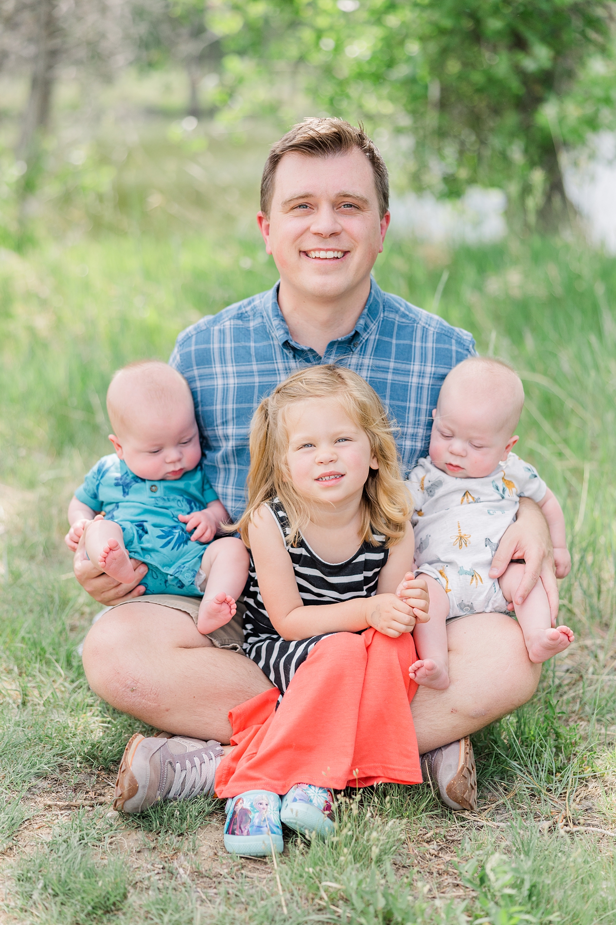 dad holds his 3 kids during Father's Day Mini Sessions