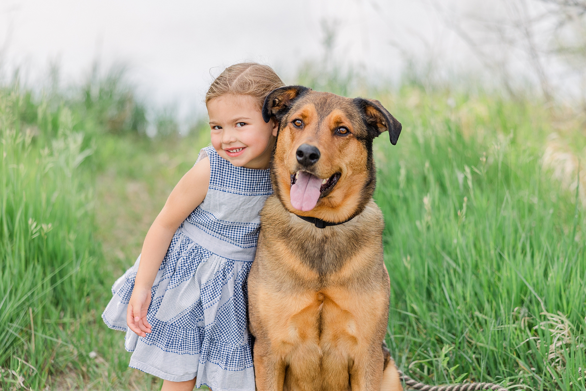 little girl with her dog during mini session at Golden Ponds