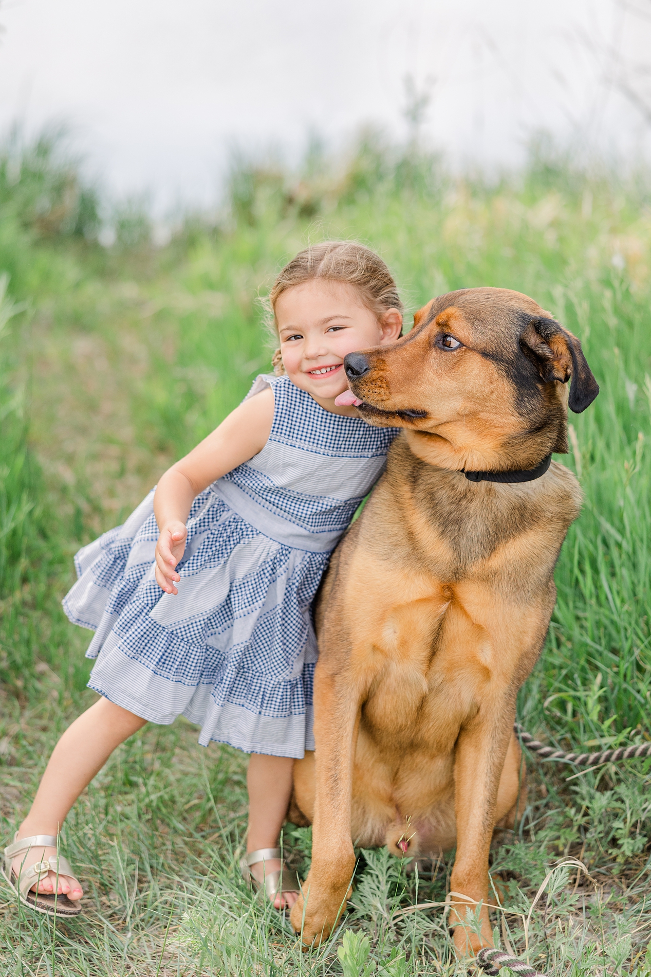 Little girl and her dog during family photos