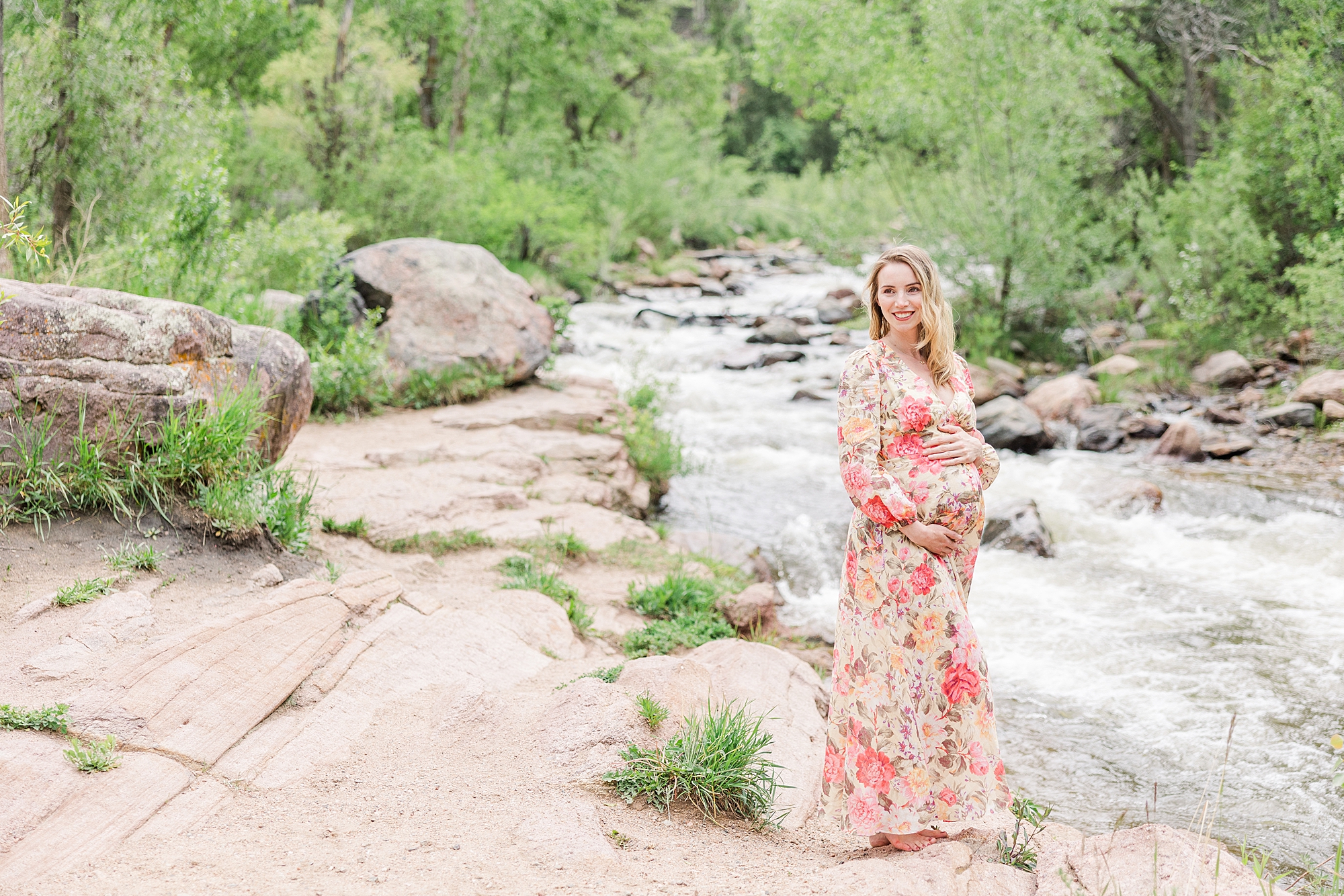 mom-to-be by the rushing water at Buckingham Park for Summer Maternity Session in Boulder, CO