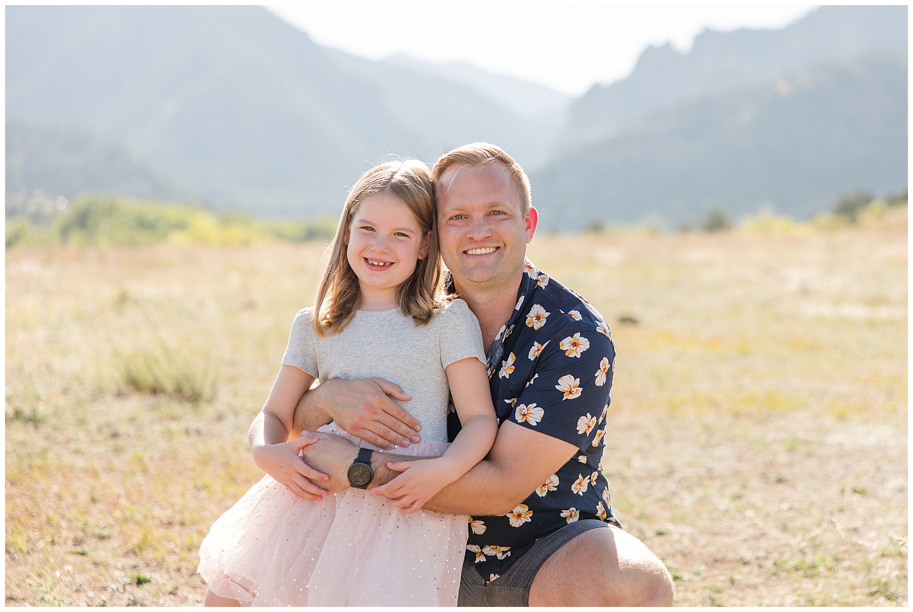 dad squatting down holding daughter on his knee for a fall photo at South Mesa Trailhead
