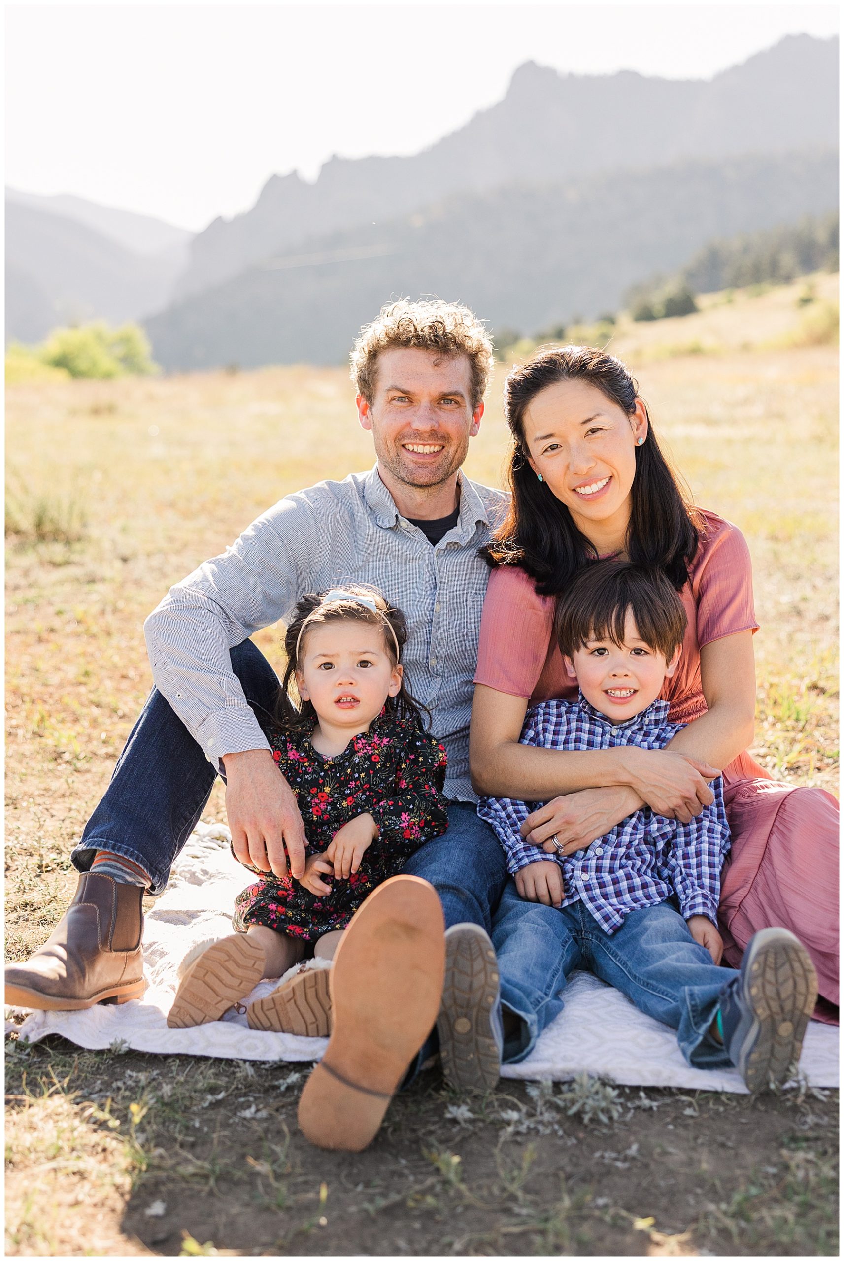 family of four sit together to be photographed at South Mesa Trailhead
