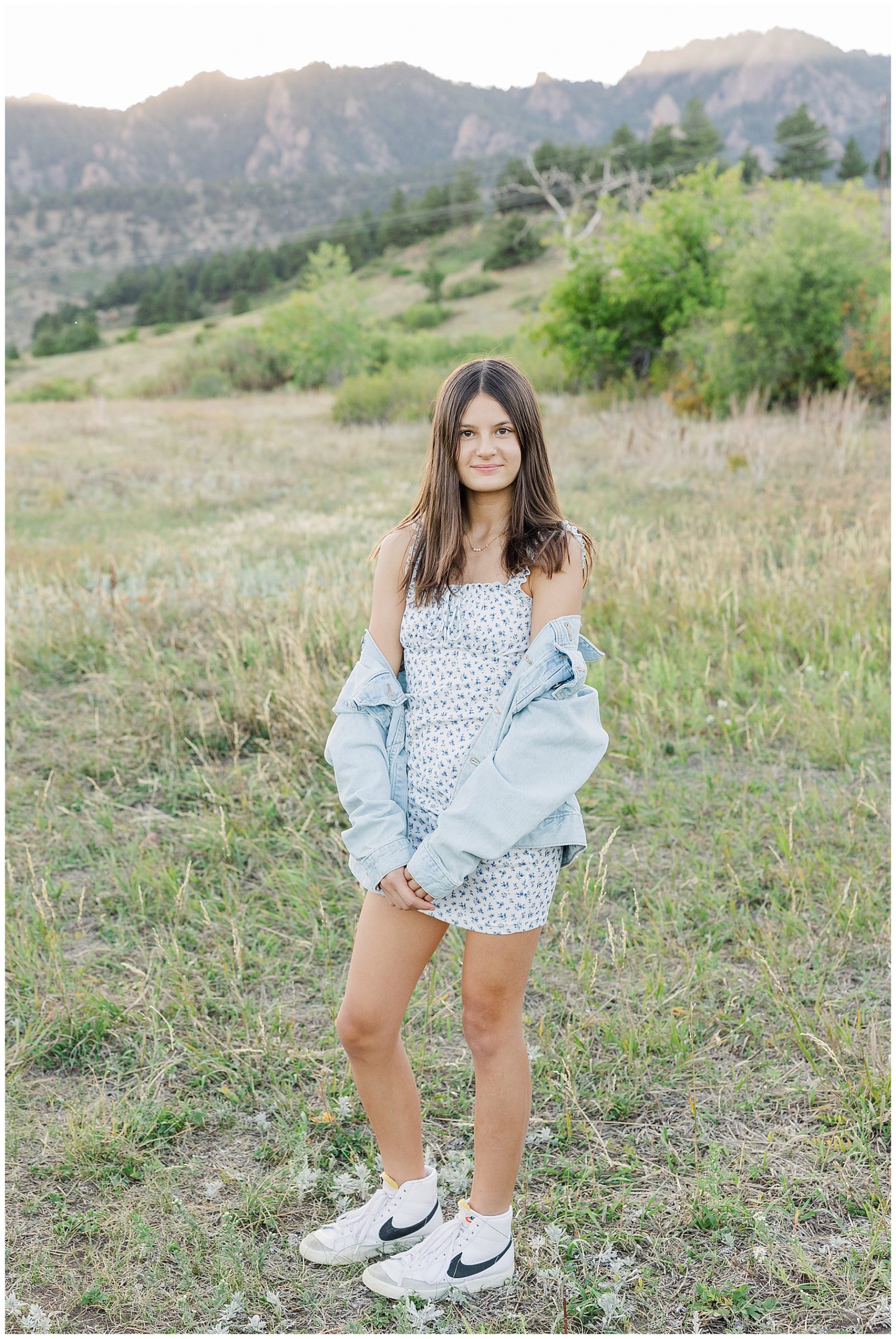 teen with off the shoulder jean jacket pose fall session in Colorado