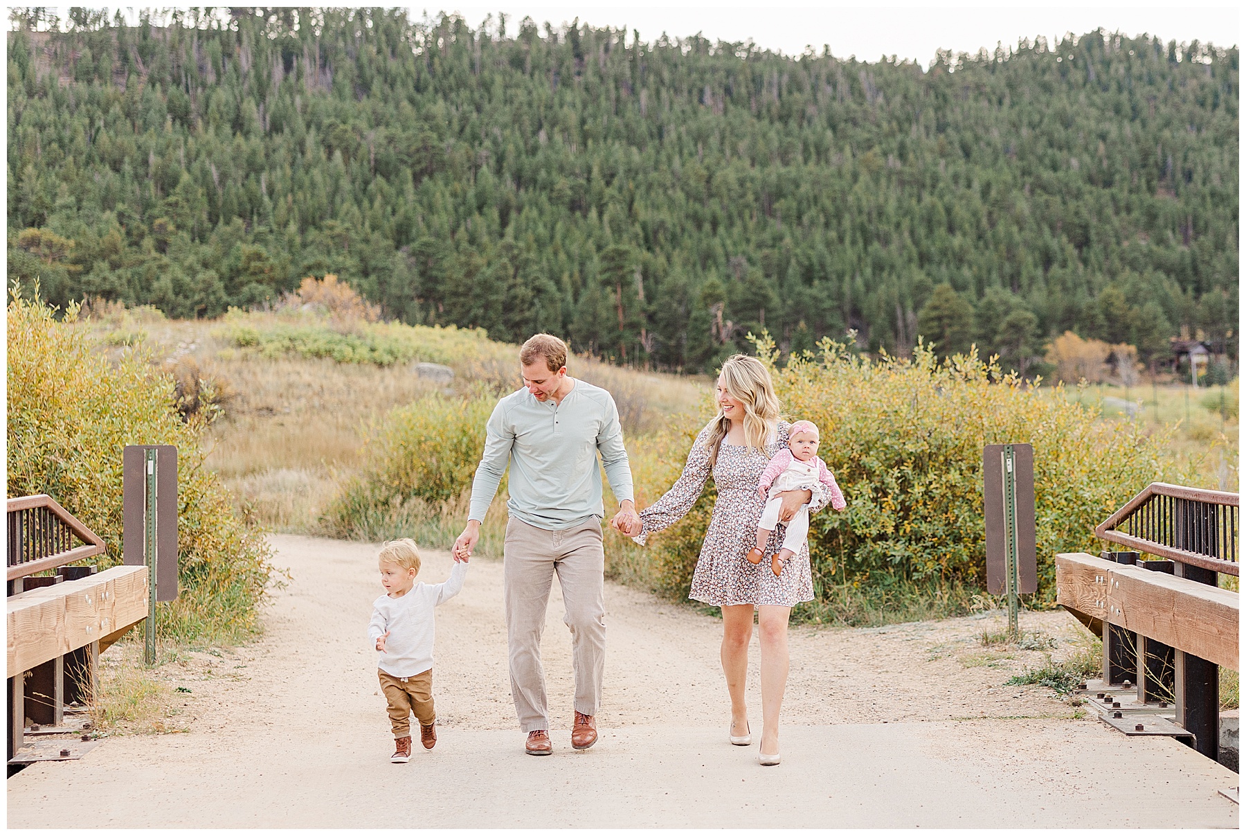 family of four looking at each other while walking on a path in CO