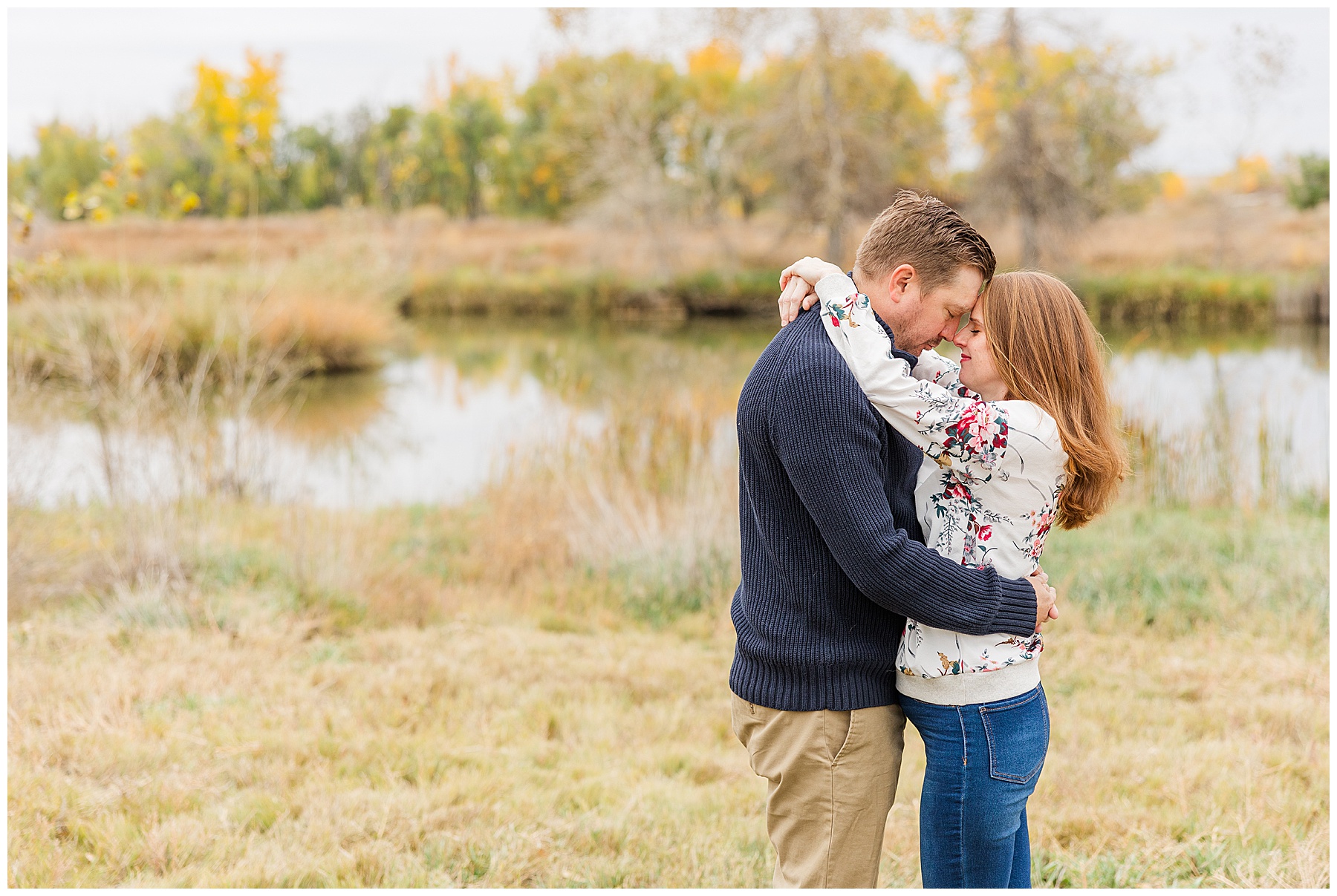 couple poses in northern Colorado holding each other touching foreheads