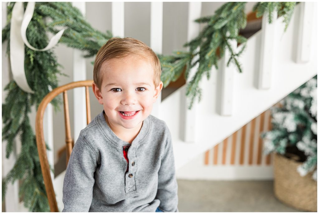 Catherine Chamberlain Photography takes Christmas minis of toddler boy on a wooden chair