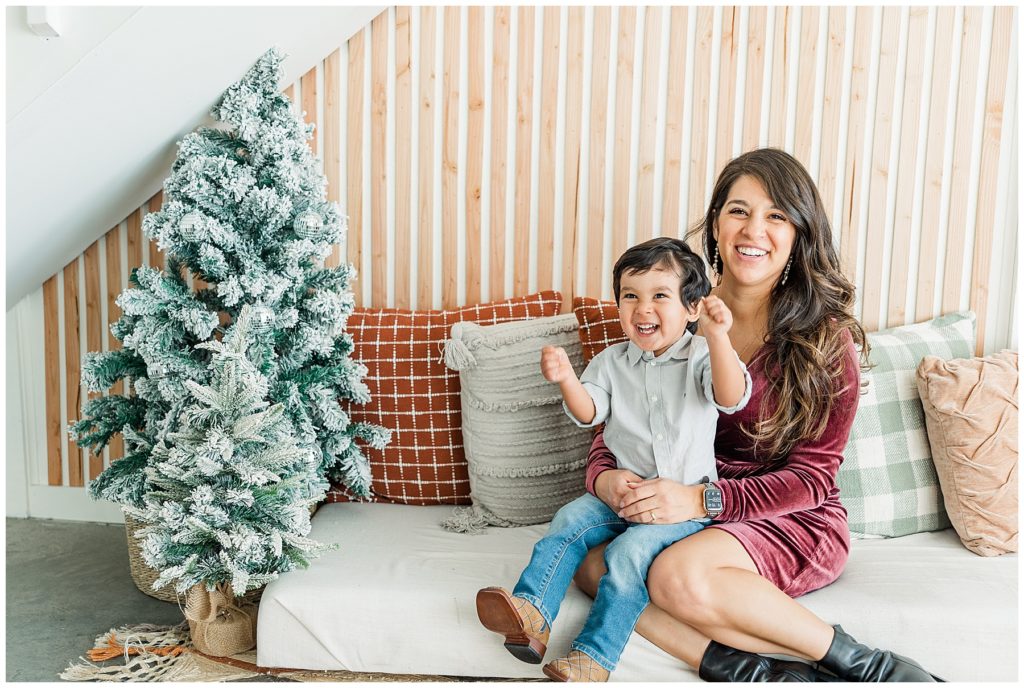 mother and son laugh gleefully during cozy farmhouse Christmas minis