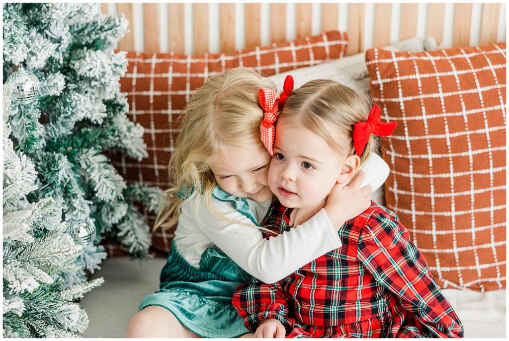 sisters hugging during Christmas minis at Sugarhill Studio, Longmont, CO