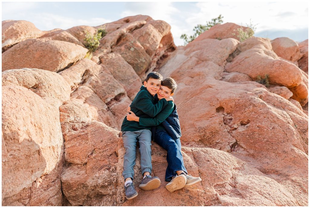 brothers hug at fall family mini sessions in Colorado Springs, Colorado for fall family mini sessions