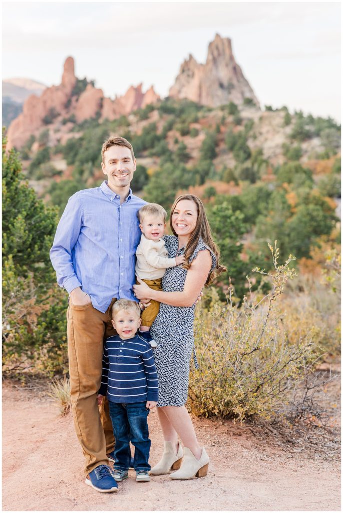 mom dad and two young boys stand for a photoshoot at Garden of the Gods