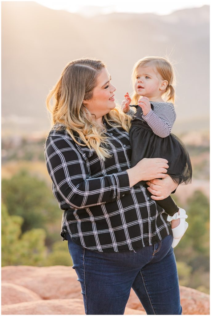 mother holds her little girls at Garden of the Gods fall family mini sessions