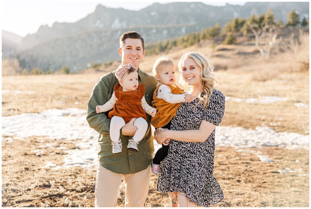siblings hold their baby girls in Boulder, CO for Cohen Extended Family Session