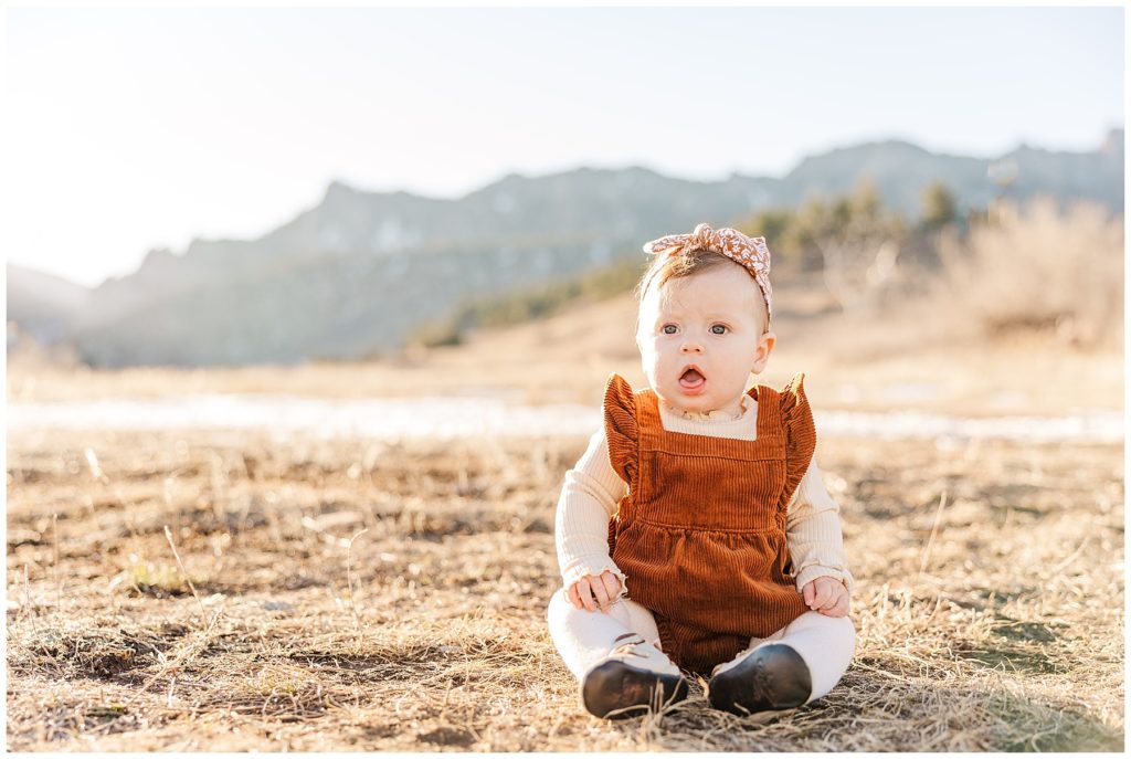 baby girl sits on the group for Cohen Extended Family Session at South Mesa Trailhead
