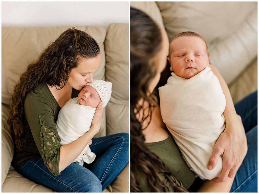 mom kissed newborn in a swaddle and hat while sitting on the couch for an in-home Colorado newborn and family session