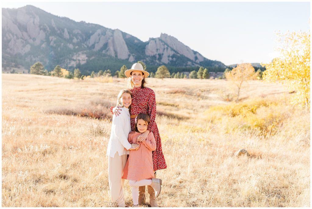 Mother and her two children pose in front of the flatirons in Boulder, CO