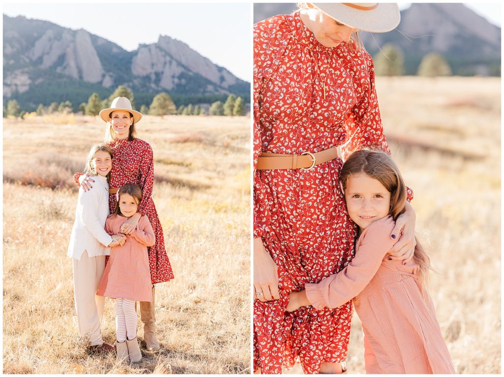 Mom wearing a wide-brimmed hat peers down at her daughter who looks at the camera during outdoor photos in Northern CO