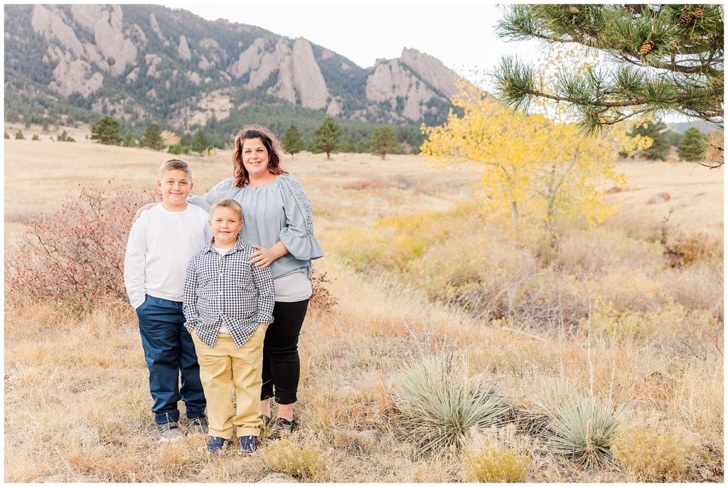 Mom and her two sons stand together for family portraits outside in Colorado 
