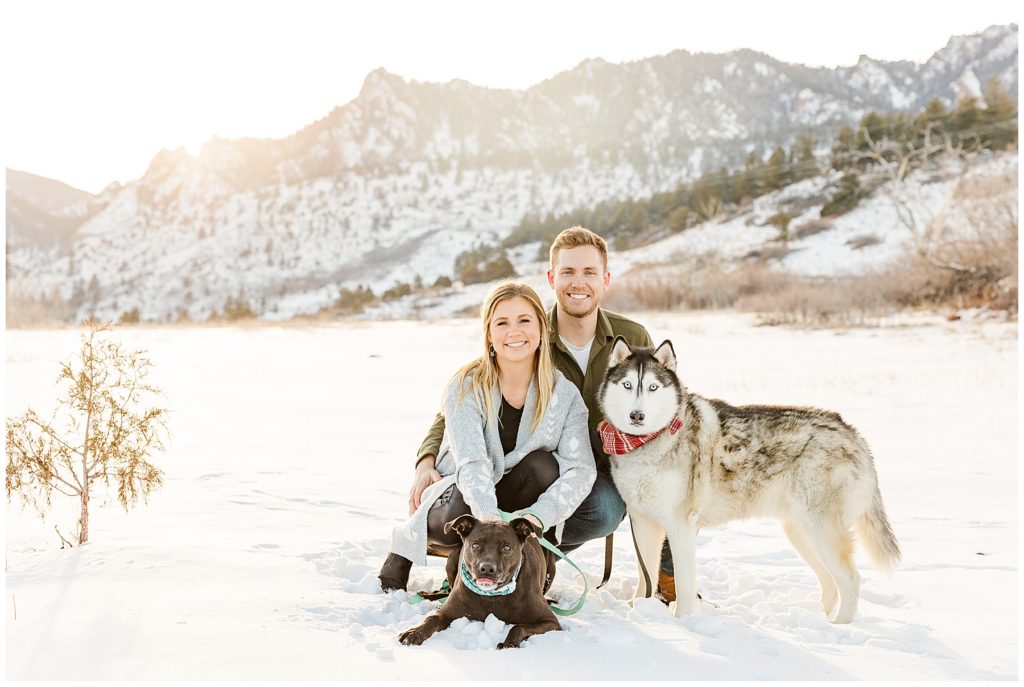 Colorado couple poses with their dogs for Boulder snowy mountain session at the South Mesa Trailhead