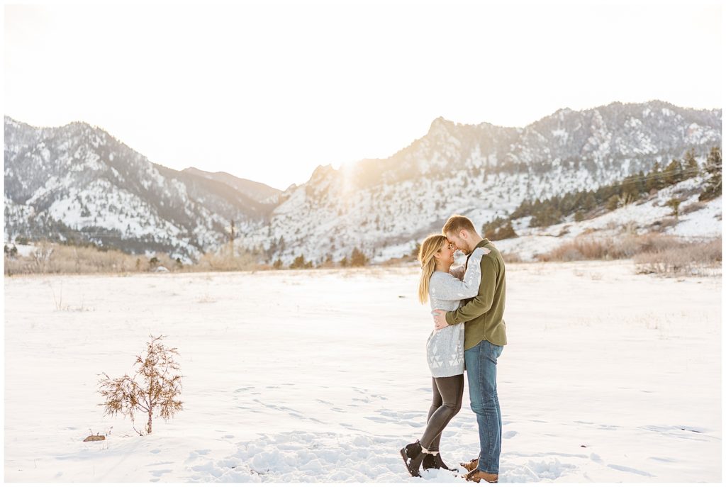 Zoomed out photo of a couple facing each other in a winter photo session by family photographer Catherine Chamberlain